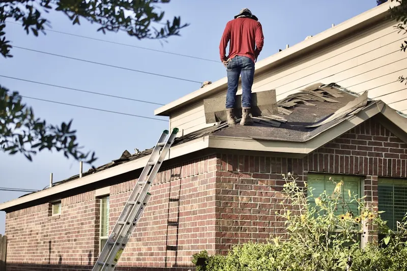Professional roofer working on a residential roof in Old Mastic